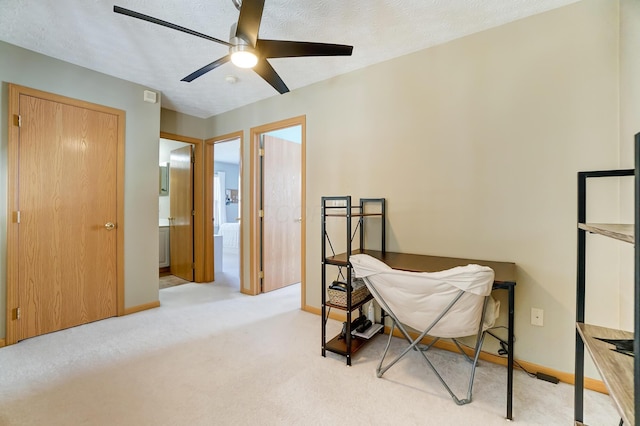 carpeted bedroom featuring ceiling fan, a textured ceiling, and ensuite bathroom