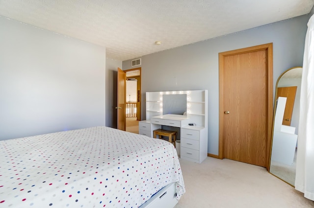 carpeted bedroom featuring a textured ceiling