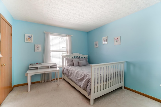 carpeted bedroom featuring a textured ceiling