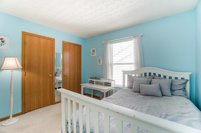 carpeted bedroom featuring a textured ceiling