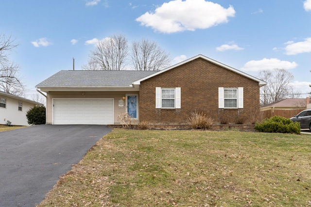 ranch-style home with a garage and a front lawn