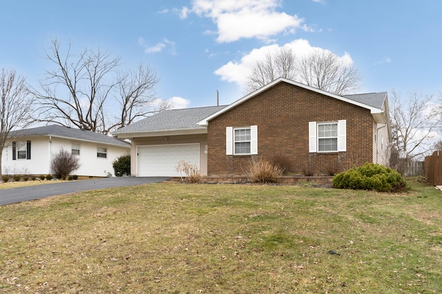 ranch-style house with a garage and a front lawn