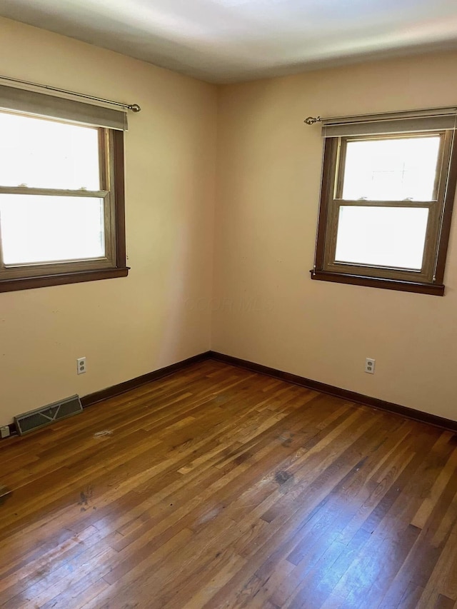 spare room with dark wood-type flooring