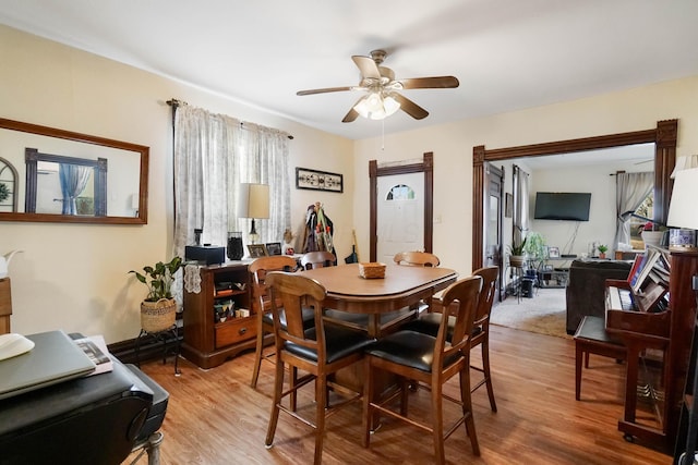 dining area featuring ceiling fan and light wood-type flooring