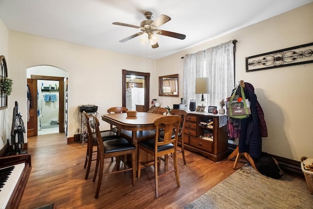 dining space with ceiling fan and wood-type flooring