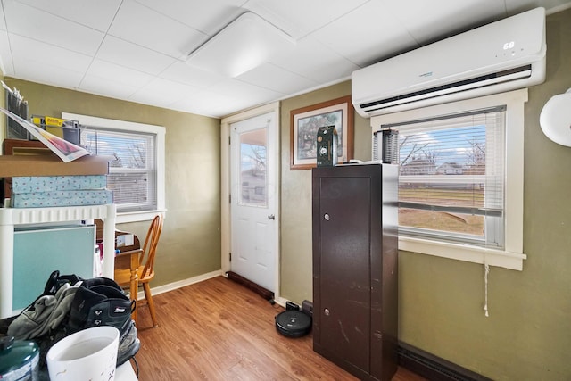 office space featuring light hardwood / wood-style flooring, plenty of natural light, and a wall mounted AC