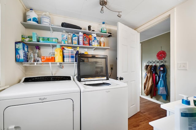 laundry area with separate washer and dryer and dark hardwood / wood-style flooring