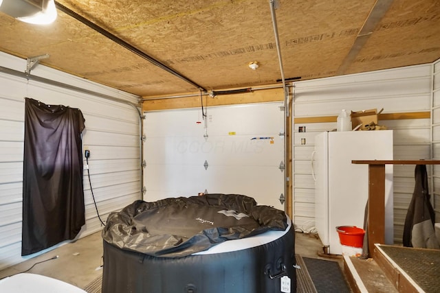 garage featuring white fridge