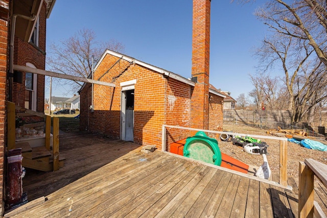 wooden terrace featuring fence