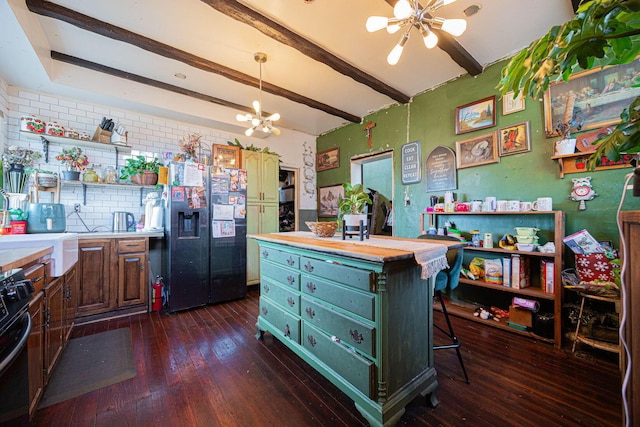 kitchen with a notable chandelier, beam ceiling, open shelves, black refrigerator with ice dispenser, and range with gas cooktop