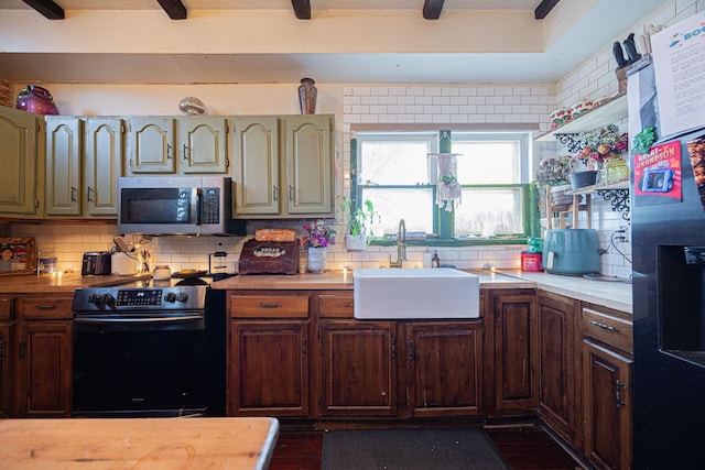 kitchen featuring decorative backsplash, stainless steel microwave, a sink, and black / electric stove