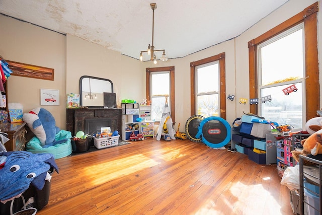 rec room with a chandelier and hardwood / wood-style floors