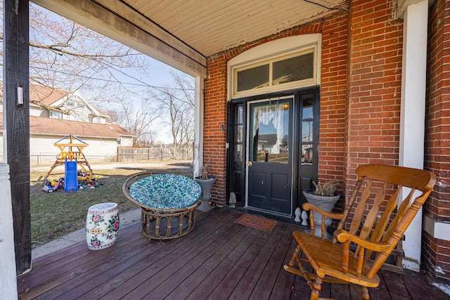 doorway to property with fence and brick siding