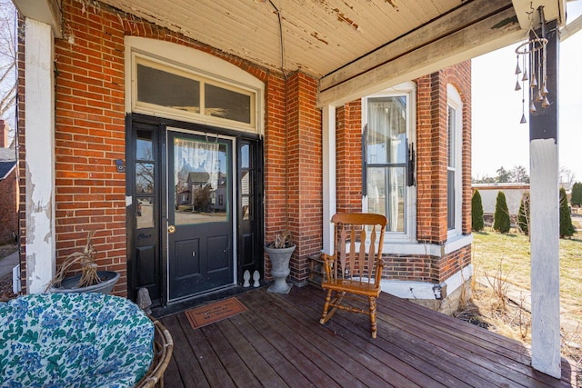 view of exterior entry featuring brick siding