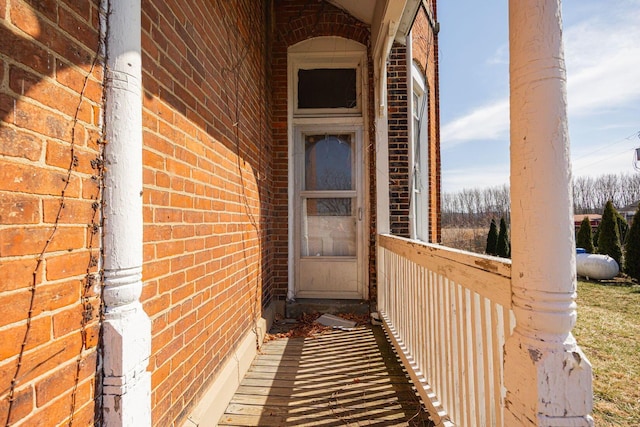 view of exterior entry with brick siding