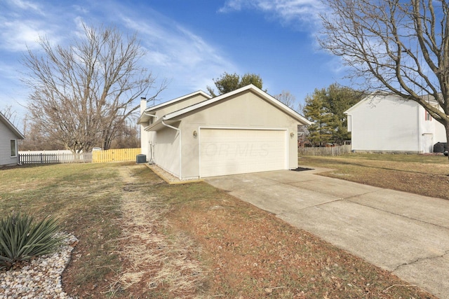 view of side of home featuring a yard and a garage