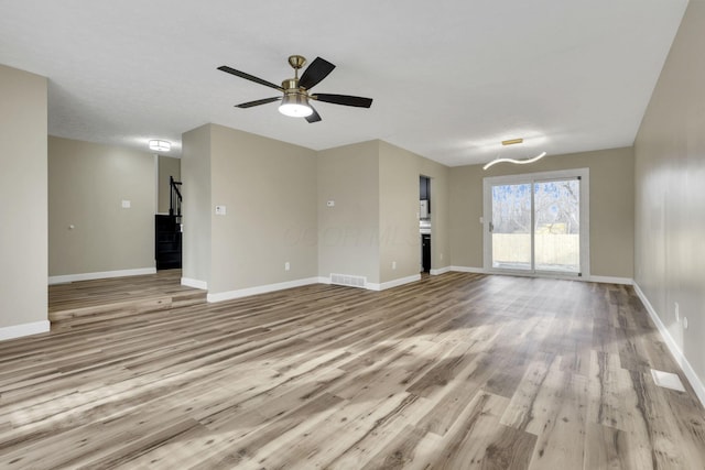 unfurnished living room with ceiling fan and light hardwood / wood-style flooring