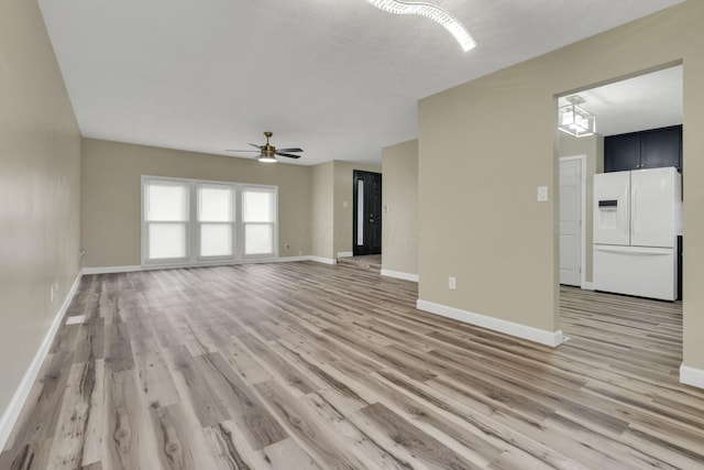 unfurnished living room with light hardwood / wood-style flooring and ceiling fan