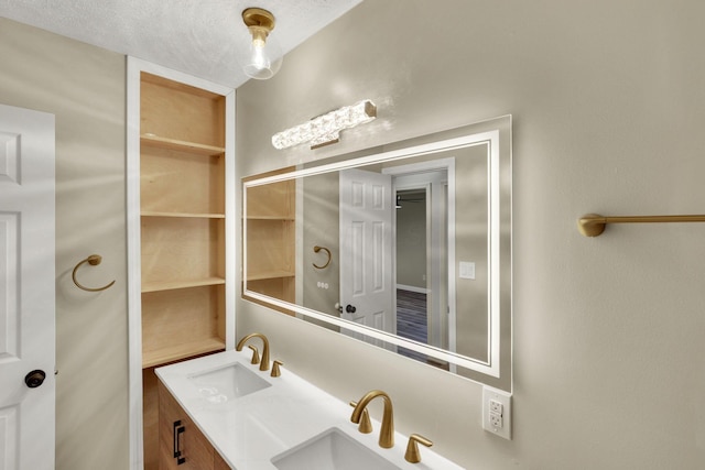 bathroom with vanity and a textured ceiling