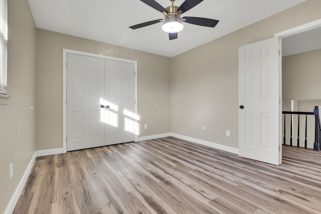 unfurnished bedroom with ceiling fan and light hardwood / wood-style floors