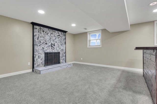 unfurnished living room featuring a fireplace and carpet