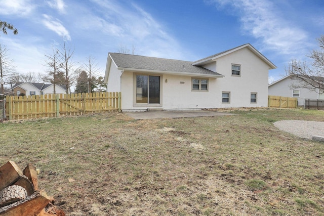 back of house with a yard and a patio area