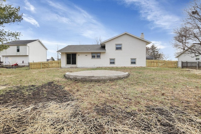 rear view of property with a patio and a lawn