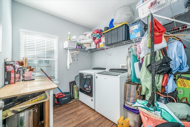 laundry room with laundry area, washer and clothes dryer, and dark wood finished floors