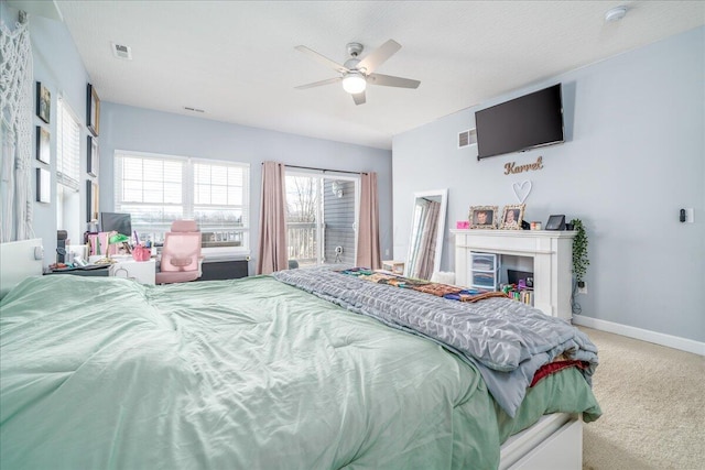 bedroom featuring visible vents, baseboards, ceiling fan, and carpet flooring