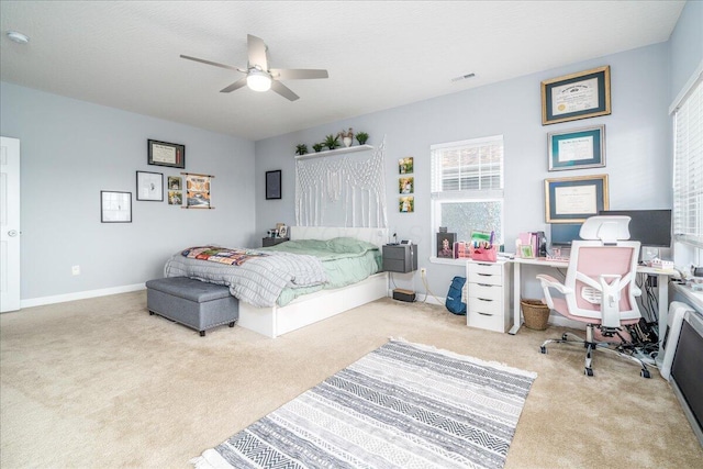 carpeted bedroom featuring visible vents, baseboards, and a ceiling fan