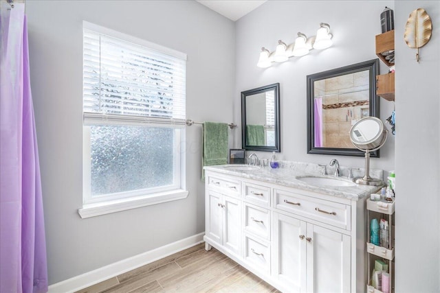 bathroom with plenty of natural light, wood-type flooring, and vanity