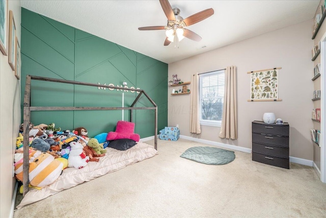 bedroom with ceiling fan, baseboards, and carpet flooring