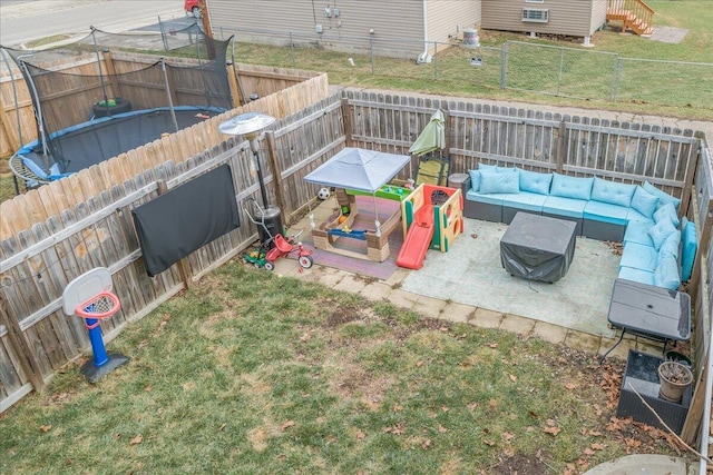 view of yard with a trampoline, outdoor lounge area, a patio, and a fenced backyard