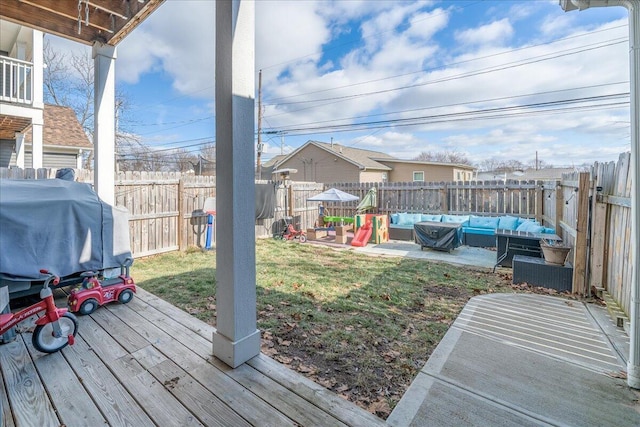 view of yard with a deck, a fenced backyard, and an outdoor living space