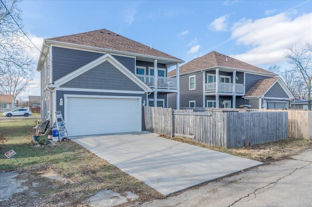 view of front facade featuring a garage and a balcony