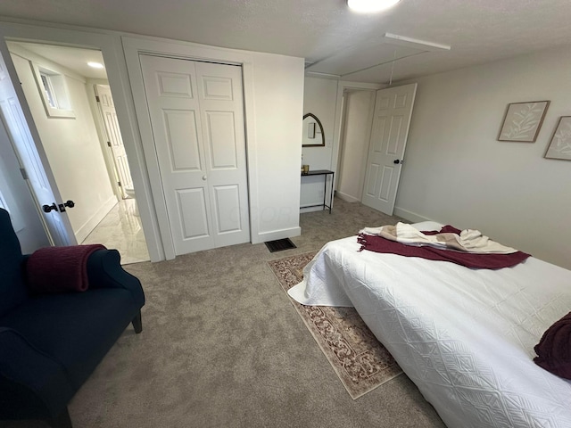 bedroom featuring light colored carpet and a closet