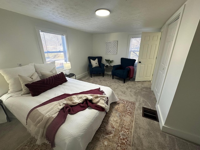 carpeted bedroom with a textured ceiling