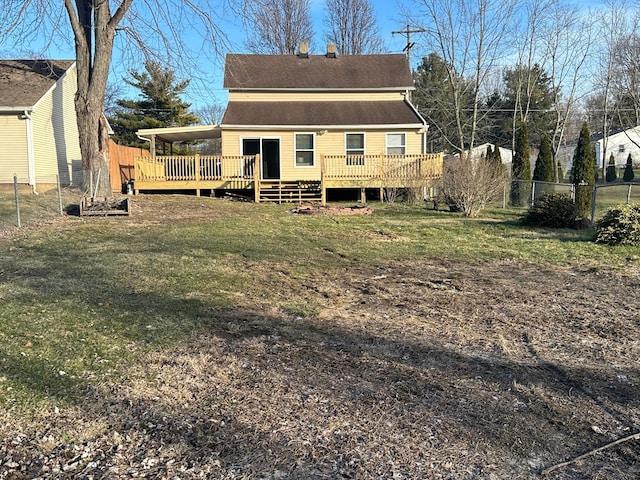 back of property with a deck and a lawn