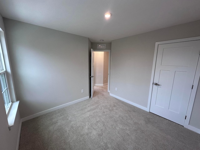 unfurnished bedroom featuring light colored carpet