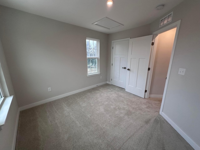 unfurnished bedroom featuring light colored carpet