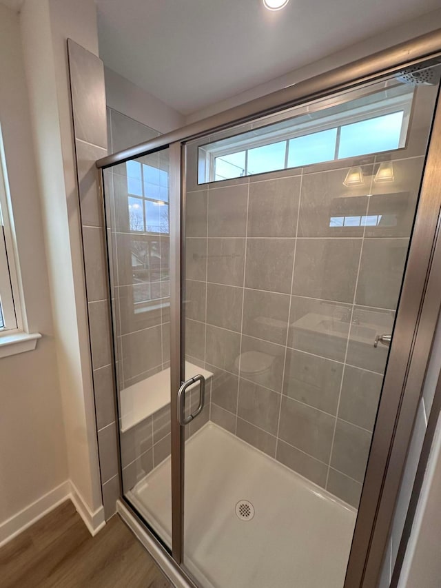 bathroom featuring hardwood / wood-style flooring and an enclosed shower