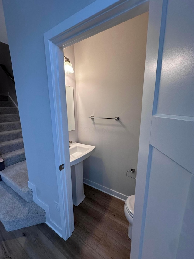 bathroom featuring hardwood / wood-style floors and toilet