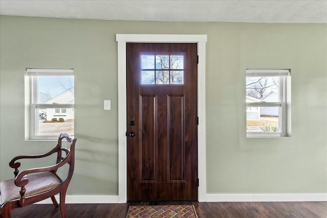 8899 Walnut St, Lakeview, OH 43331 - entryway with dark wood-type flooring and a textured ceiling