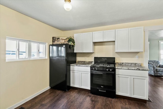 8899 Walnut St, Lakeview, OH 43331 - kitchen with white cabinets, dark hardwood / wood-style floors, light stone countertops, and black appliances