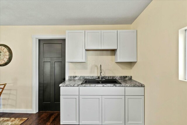 8899 Walnut St, Lakeview, OH 43331 - kitchen featuring dark hardwood / wood-style flooring, sink, and white cabinets
