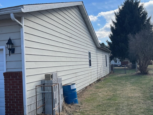 view of side of home with a yard