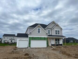 5467 Scotch Woods Dr, Grove City, OH 43123 - view of front of house with covered porch and dirt driveway