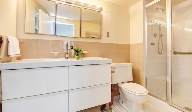 bathroom featuring tile walls, tile patterned flooring, vanity, an enclosed shower, and toilet