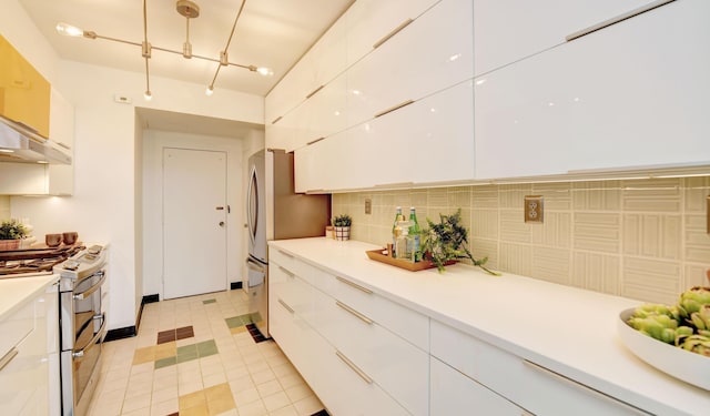 kitchen with tasteful backsplash, stainless steel appliances, white cabinets, and light tile patterned flooring