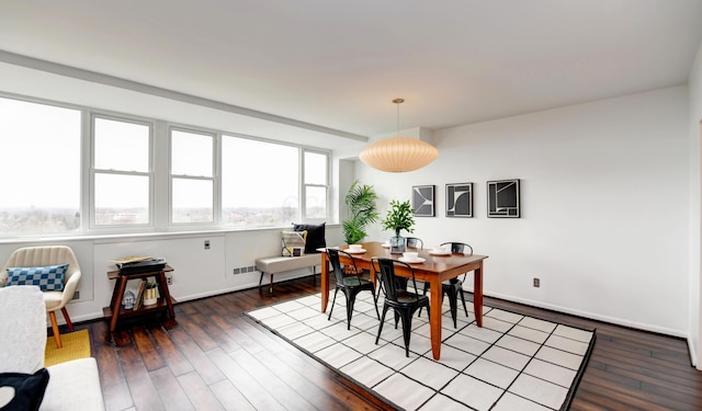 dining area with dark hardwood / wood-style floors